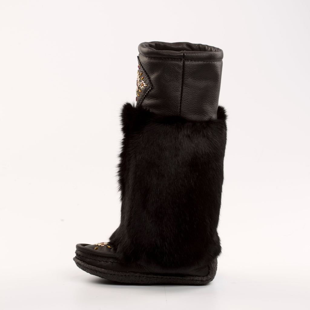 Black fur mukluk boots with a white background