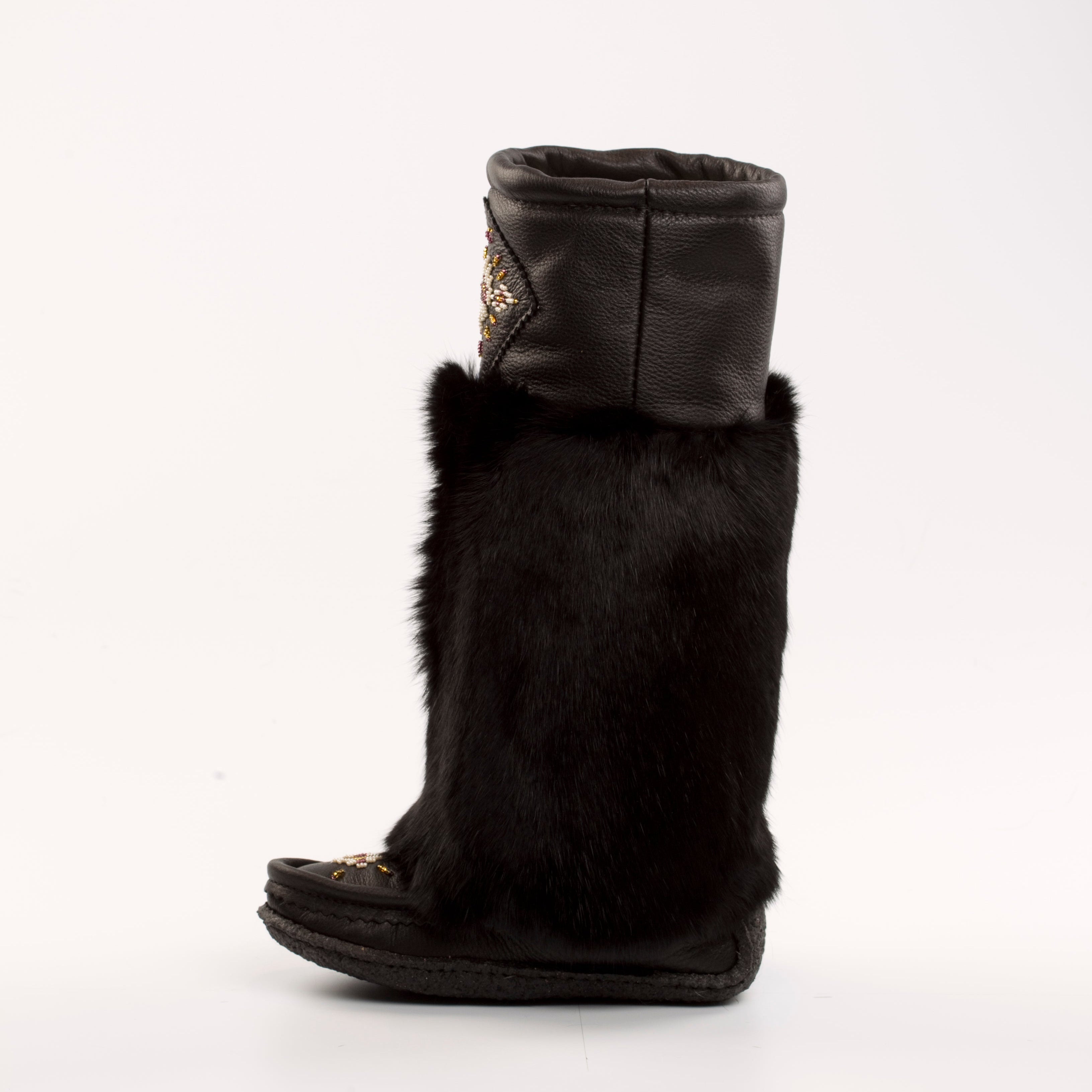Black fur mukluk boots with a white background