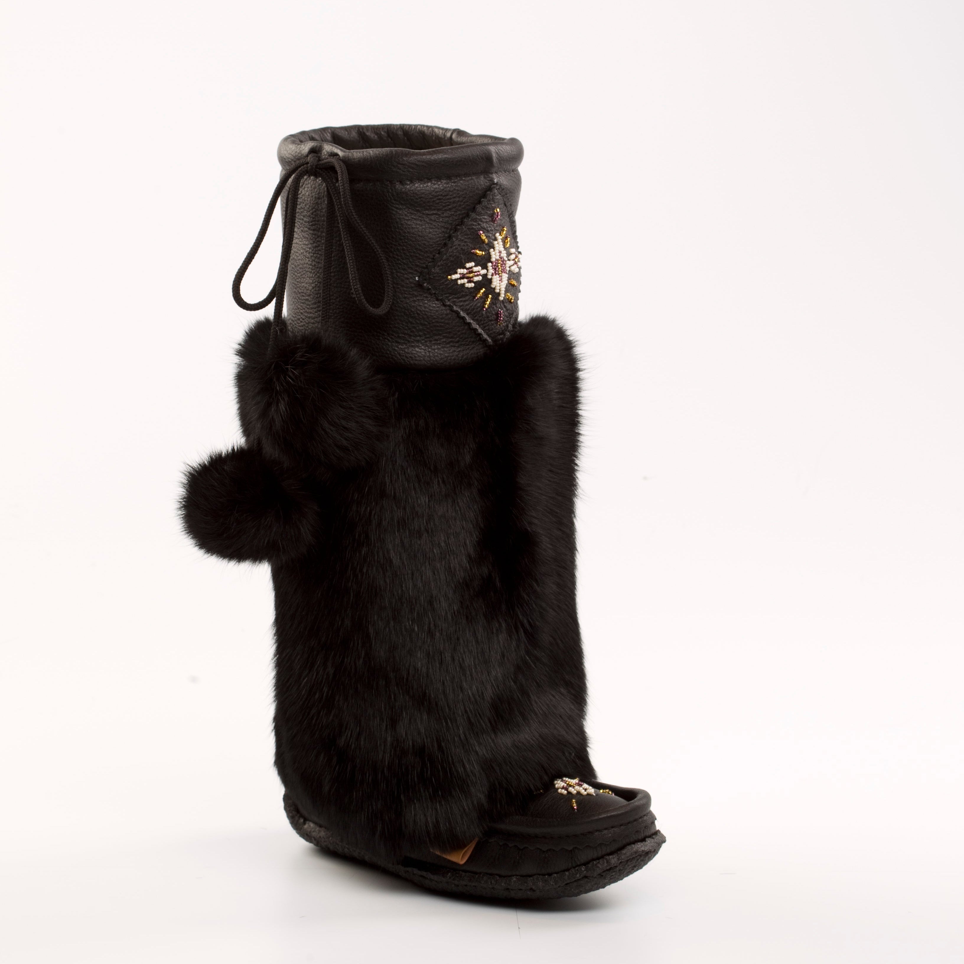 Black Mukluks with fur trim on a white background