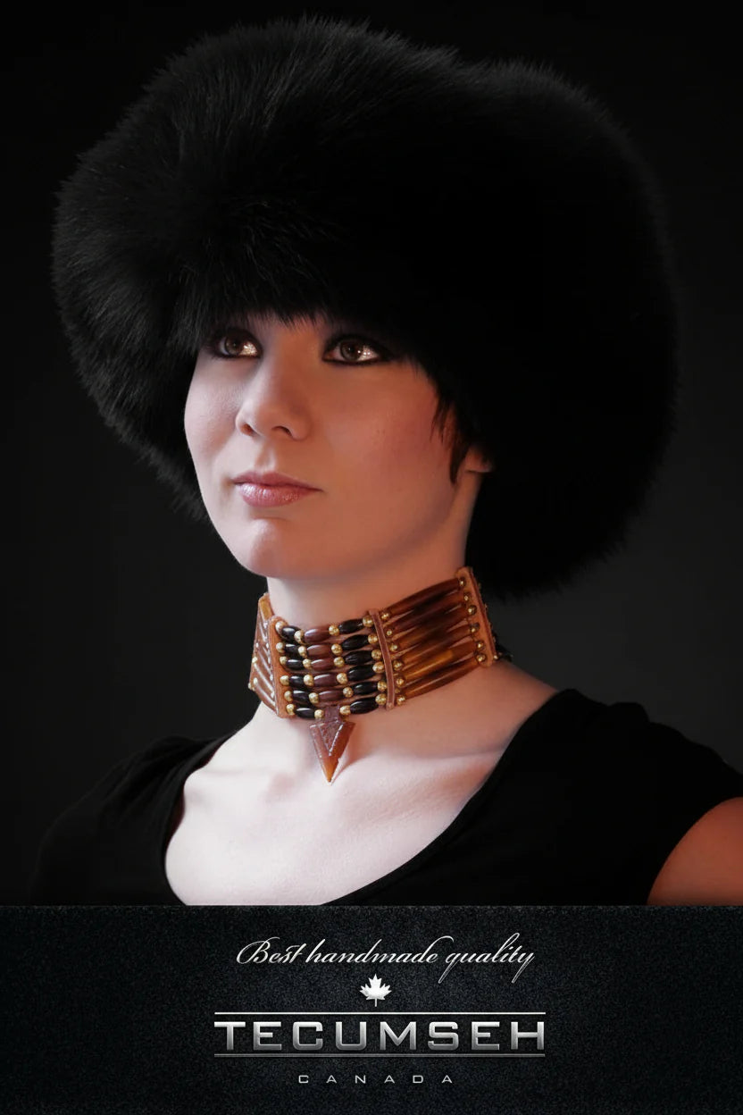 Person wearing a fur hat and decorative necklace with 'Tecumseh Canada' branding on a black background.