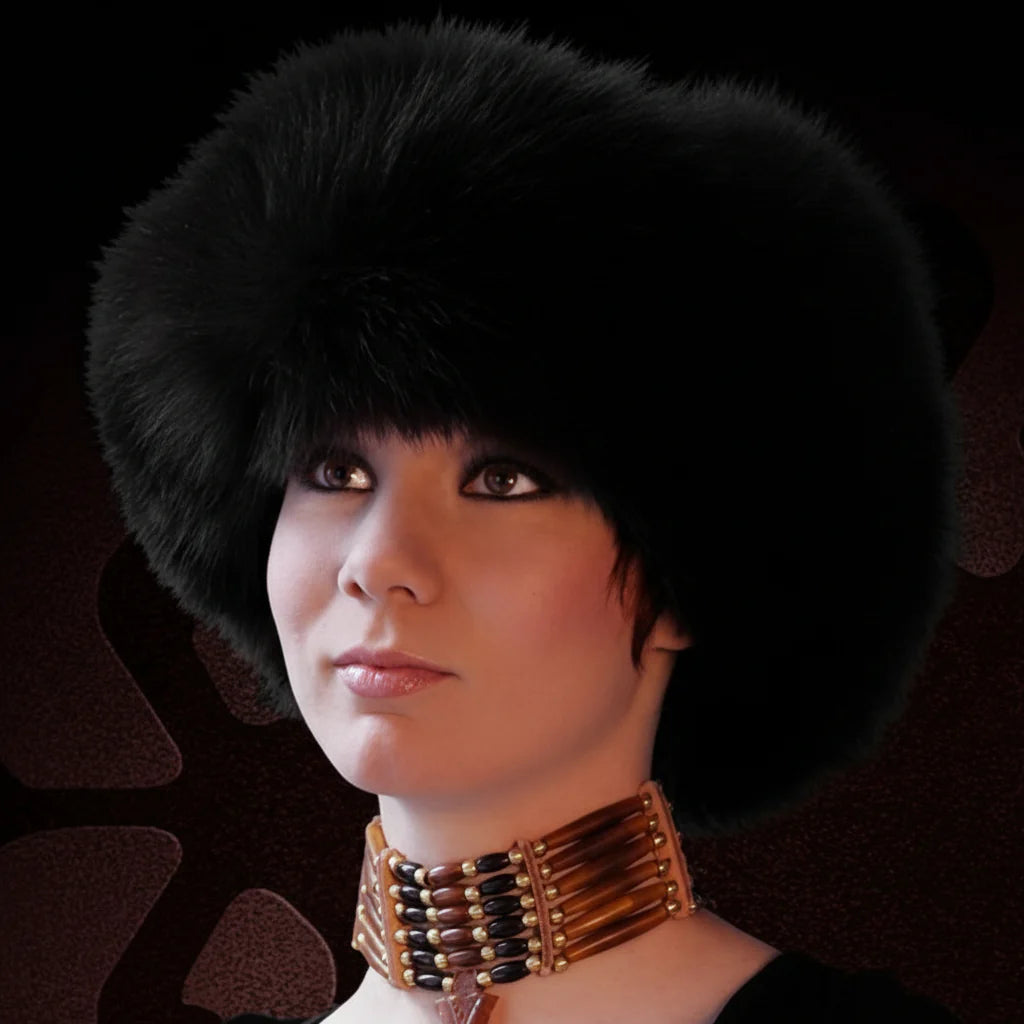 Person wearing a black fur hat and a decorative necklace against a dark background