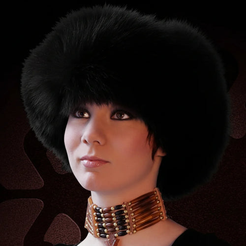 Person wearing a black fur hat and a decorative necklace against a dark background