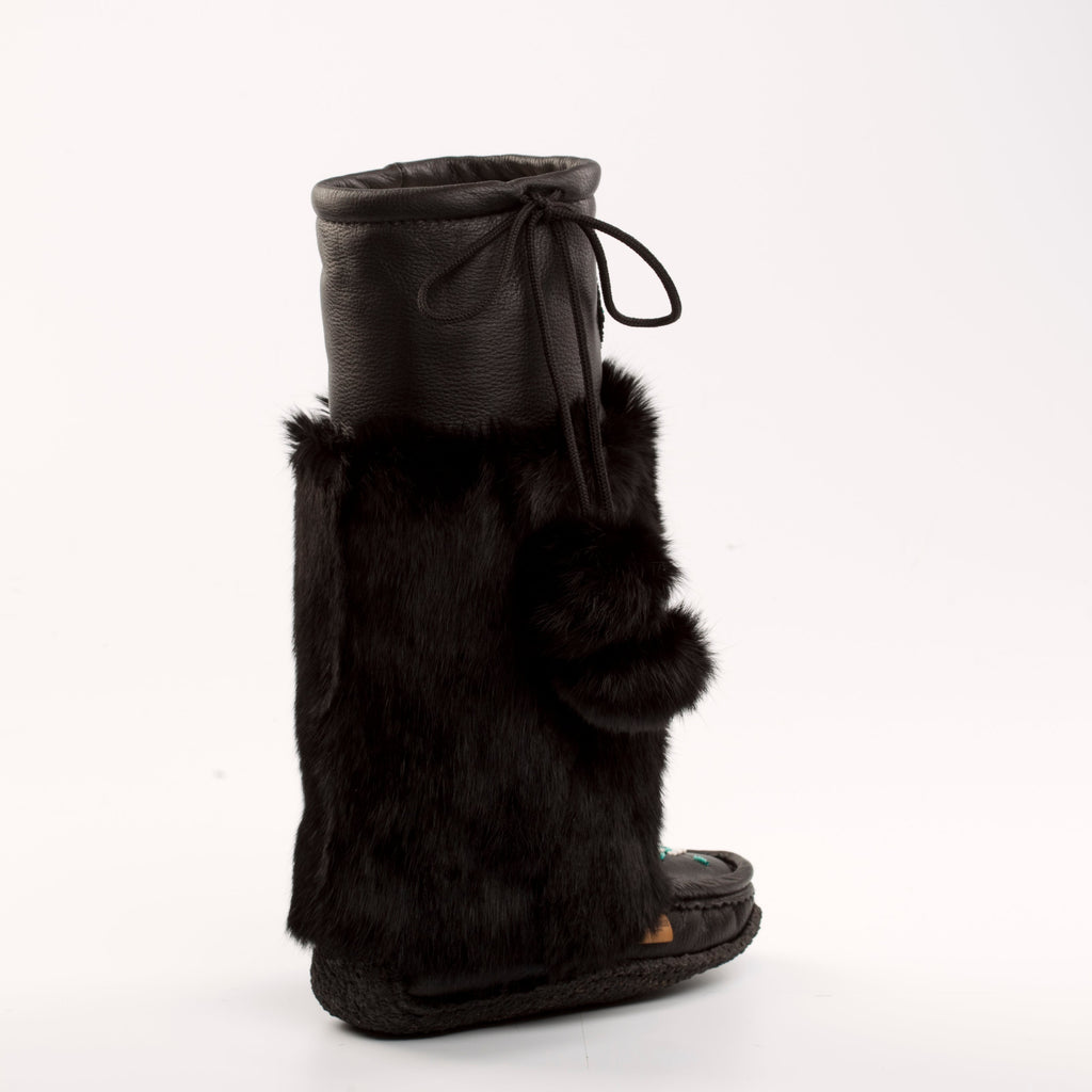 Black fur-trimmed mukluk boot on a white background