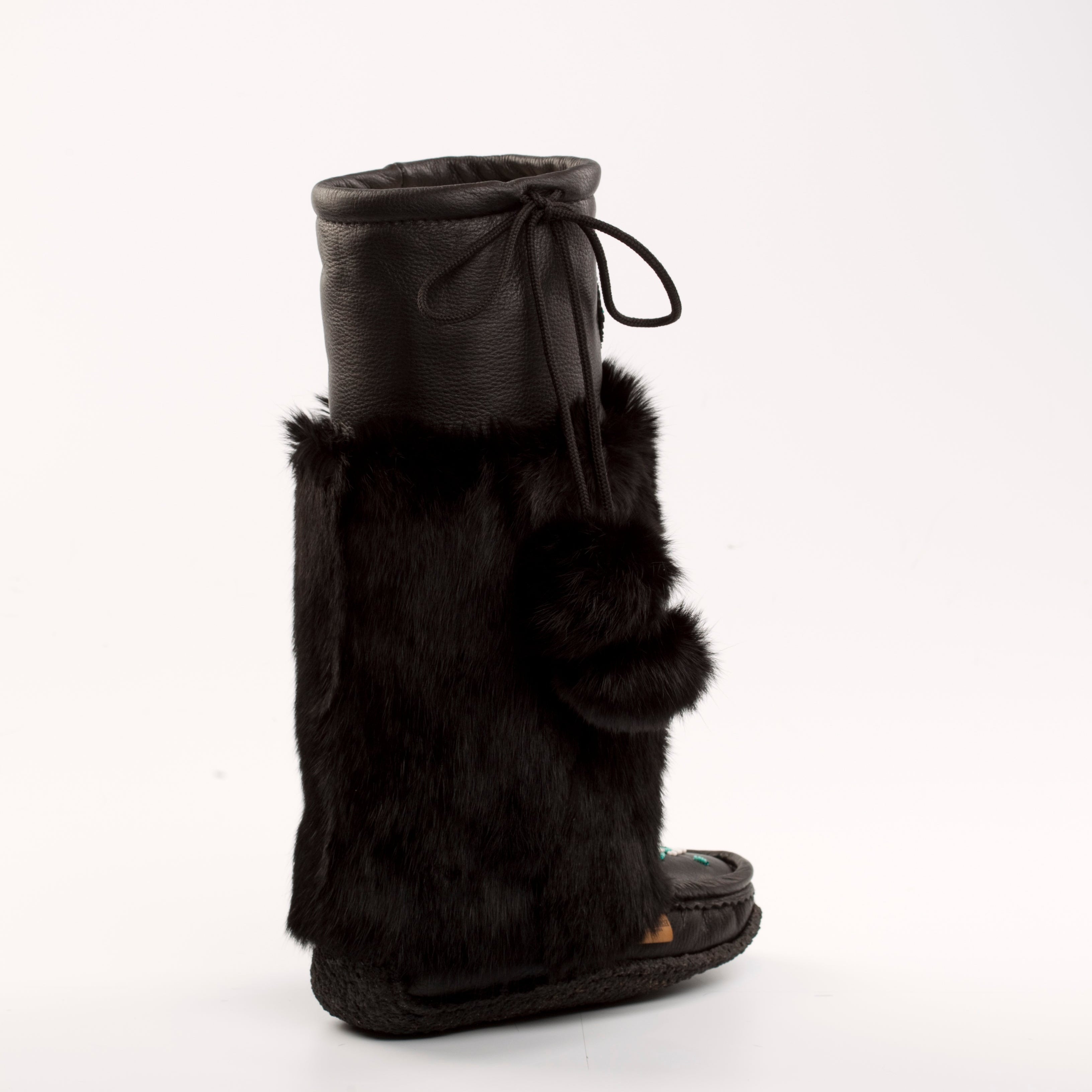 Black fur-trimmed mukluk boot on a white background