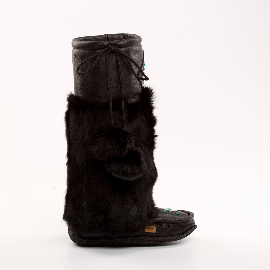 Black fur mukluks with a bow on a white background