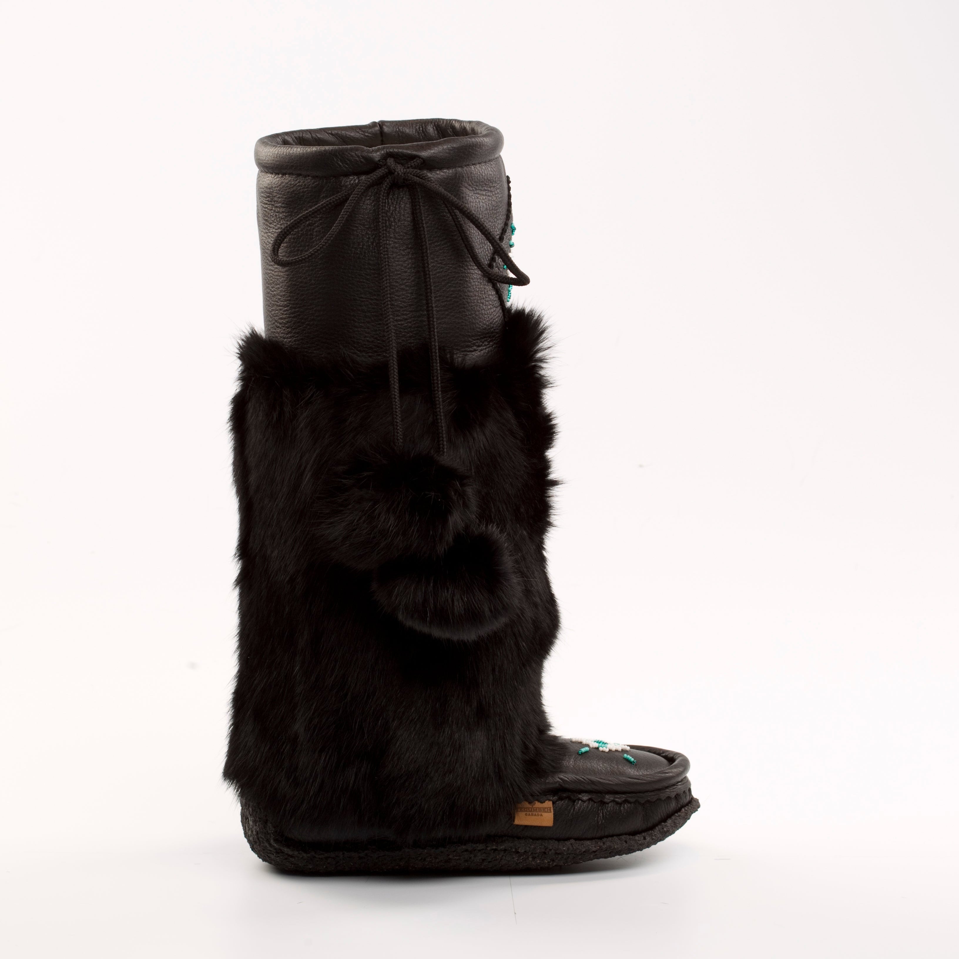 Black fur mukluks with a bow on a white background