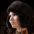 Person wearing a dark fur hat with a blurred background