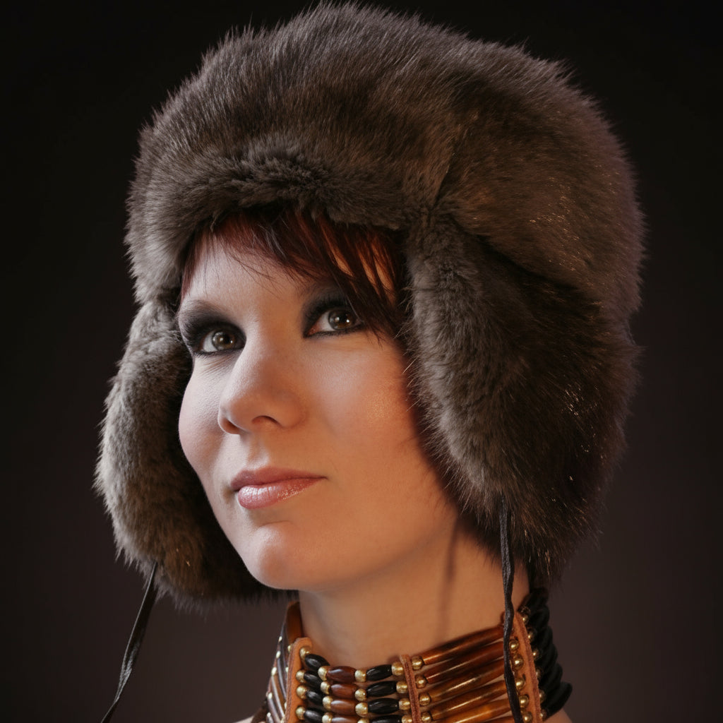 Woman wearing a fur hat against a dark background