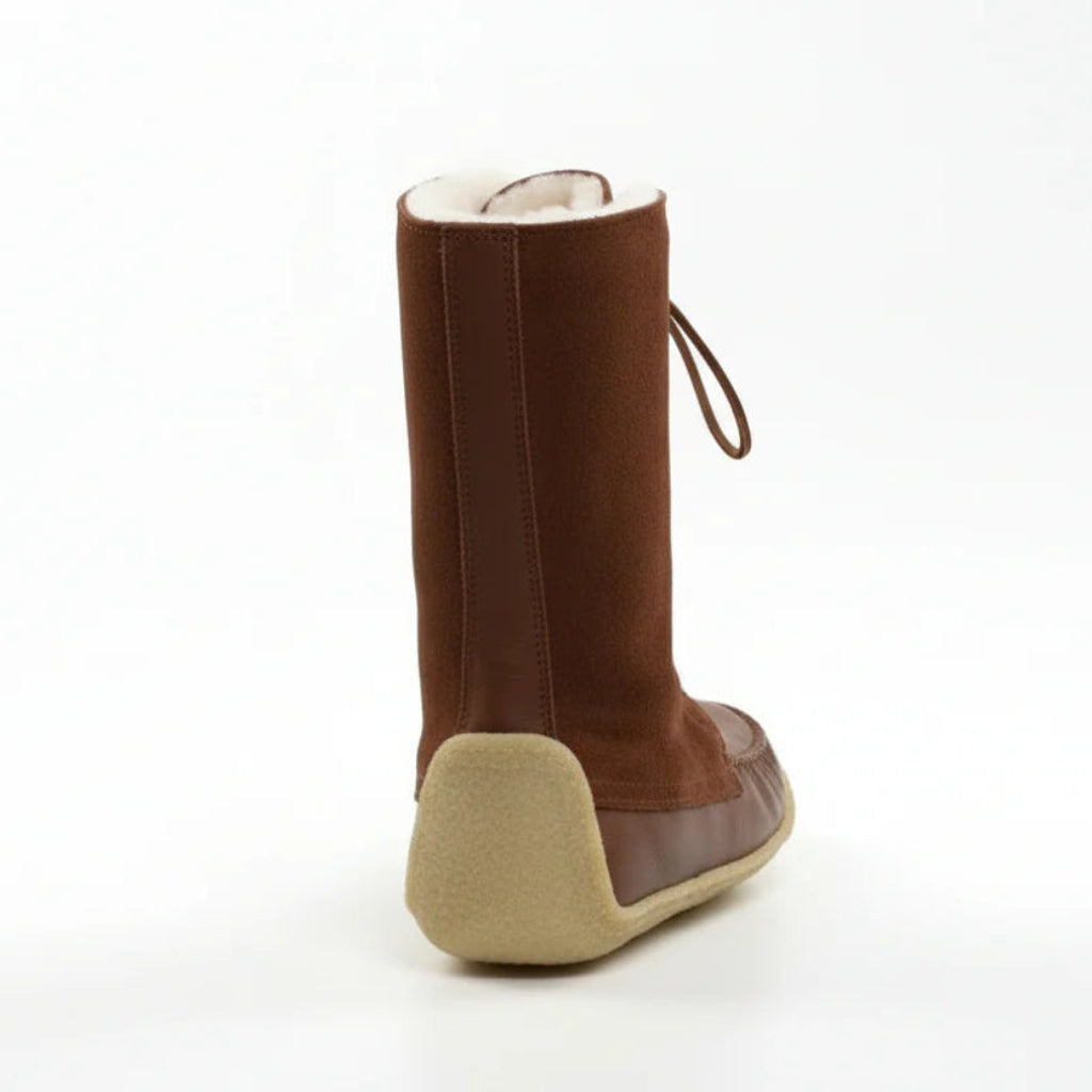Brown boot with beige sole on a white background