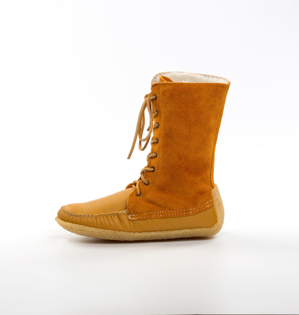 Tan boot with white lining on a white background