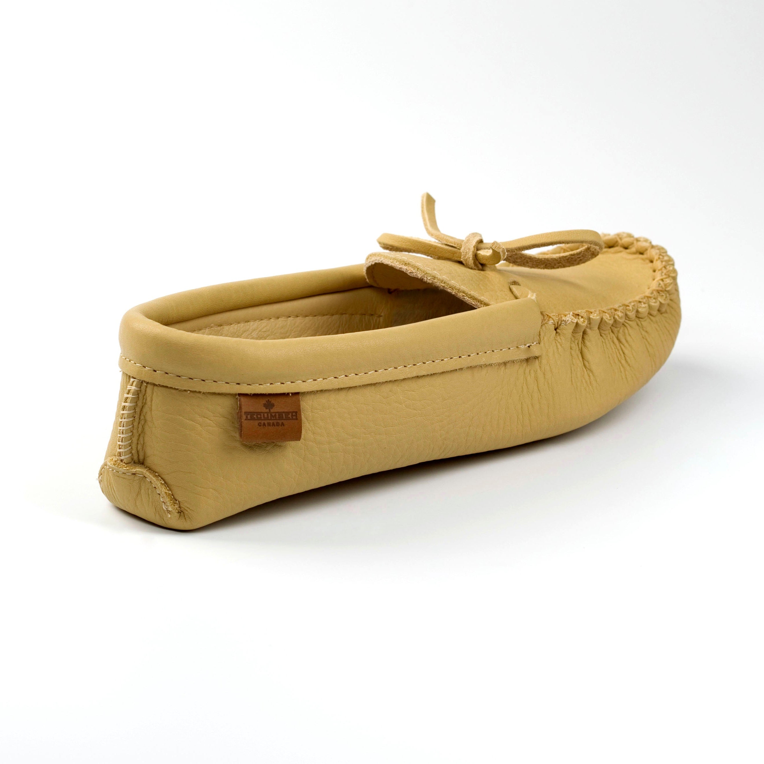 Beige moccasin shoe on a white background