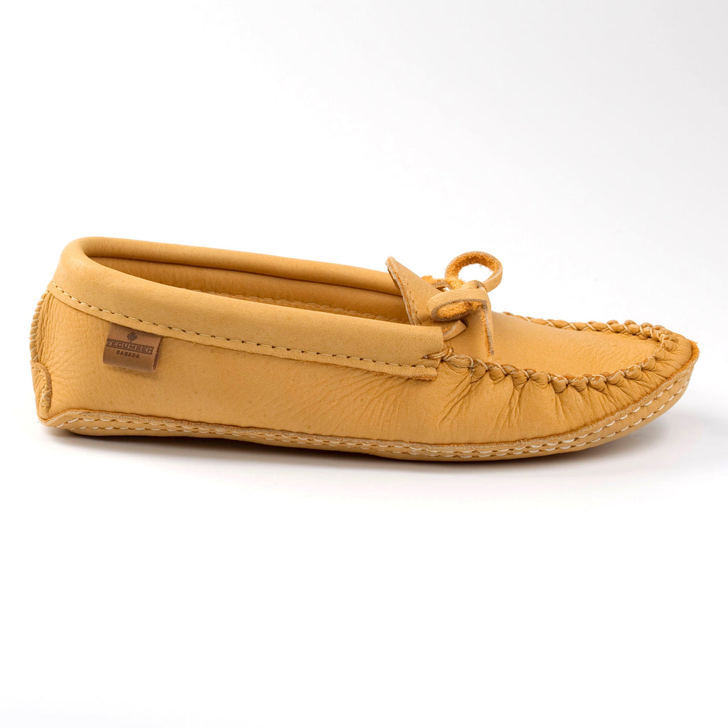 Tan moccasin slipper on a white background