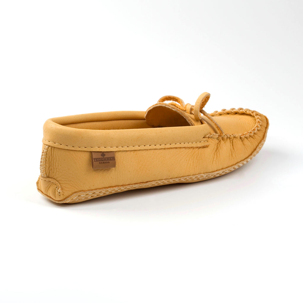 Tan moccasin shoe on a white background