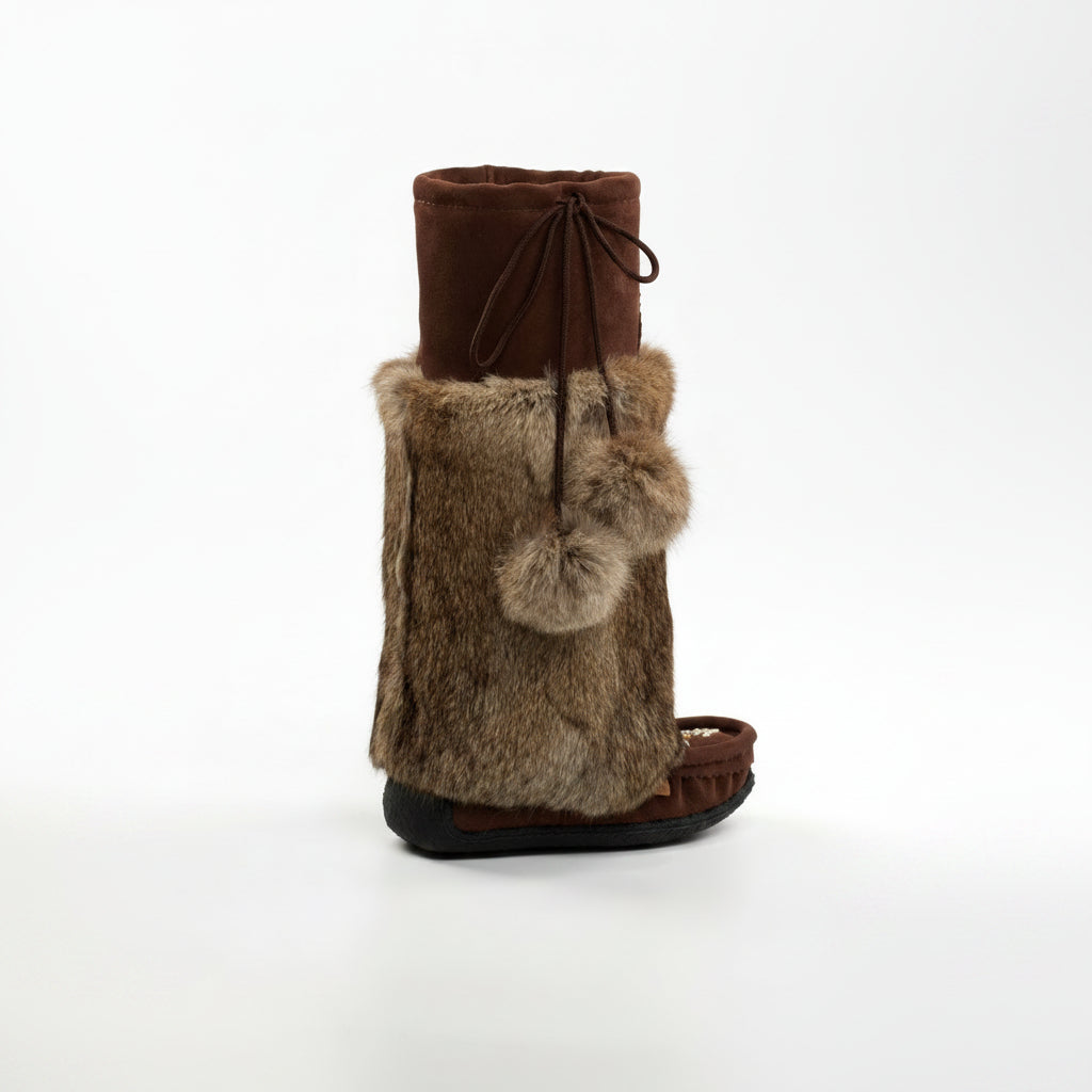 Brown boot with fur gaiter and pom-poms on a white background