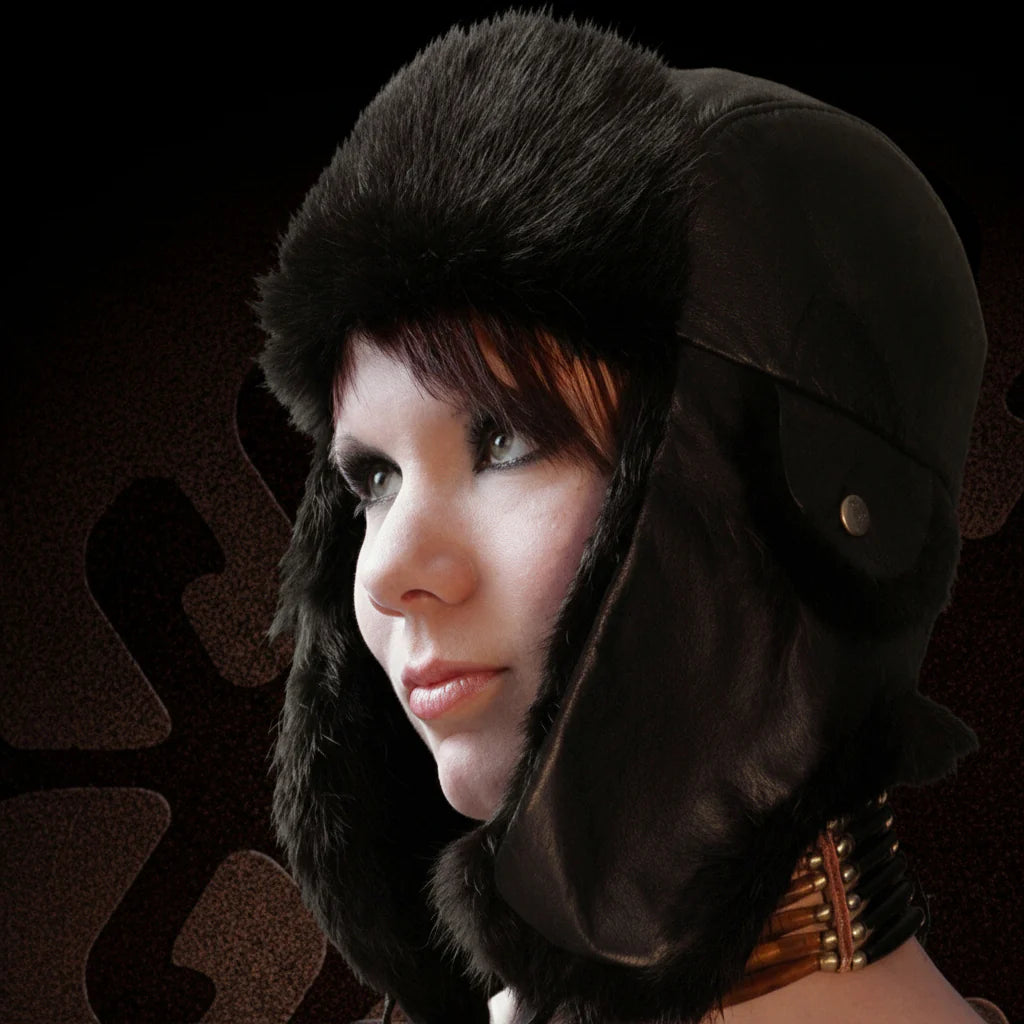 Person wearing a black fur hat with a dark background