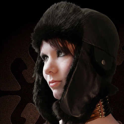 Person wearing a black fur hat with a dark background