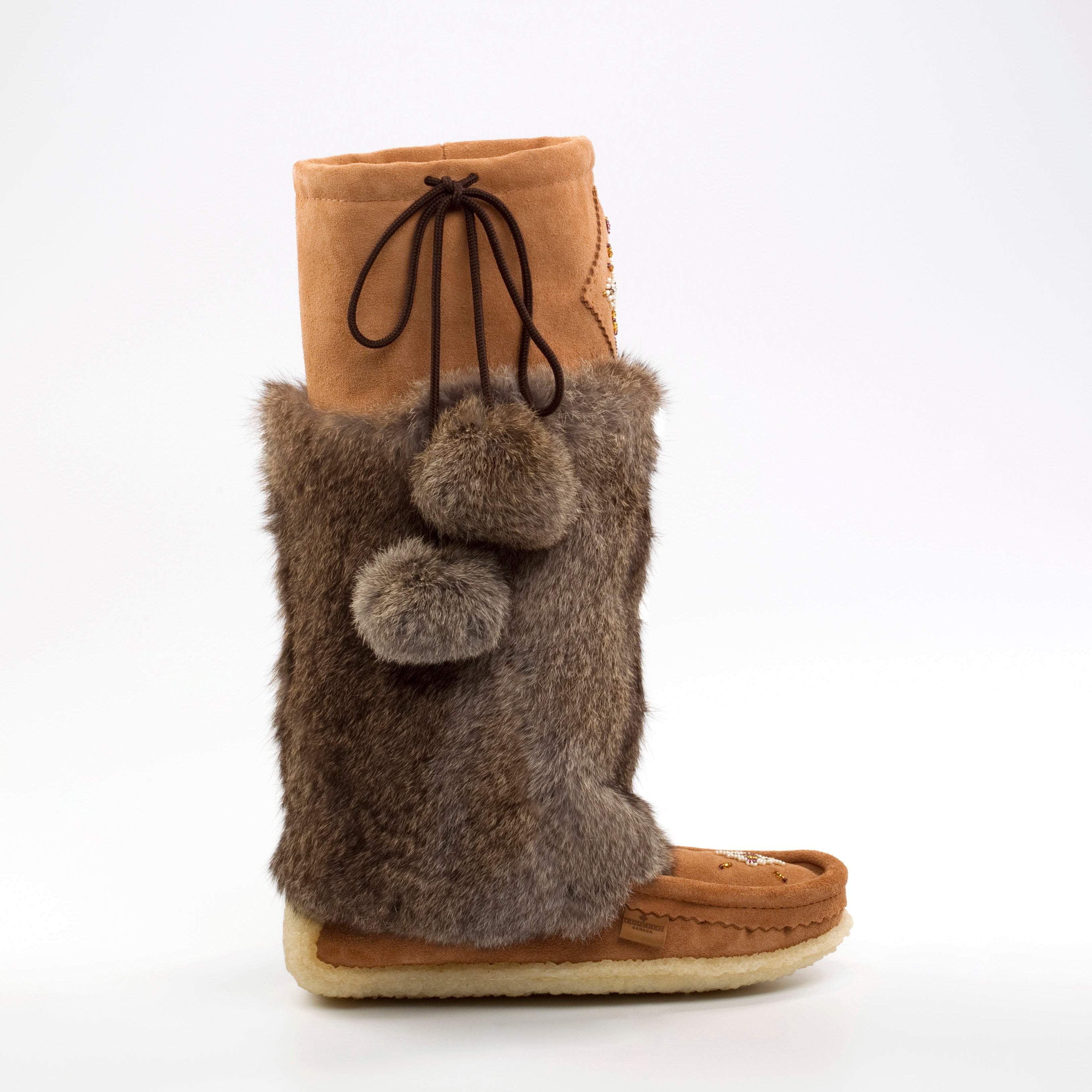 Brown fuzzy mukluk boot with a white background
