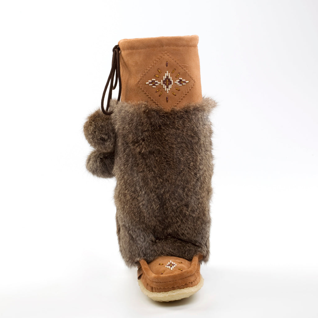 Brown fur mukluks with a decorative beading on a white background