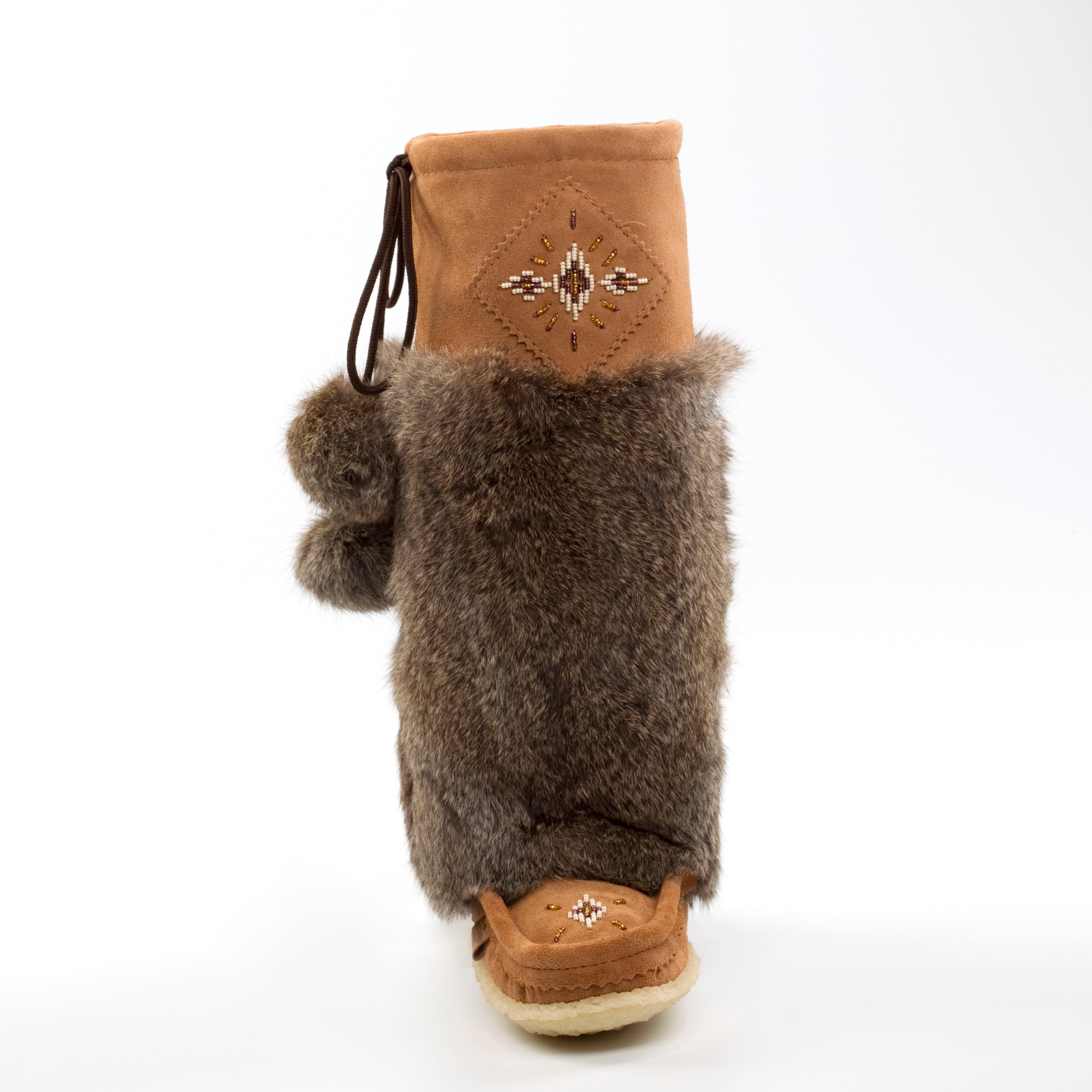 Brown fur mukluks with a decorative beading on a white background