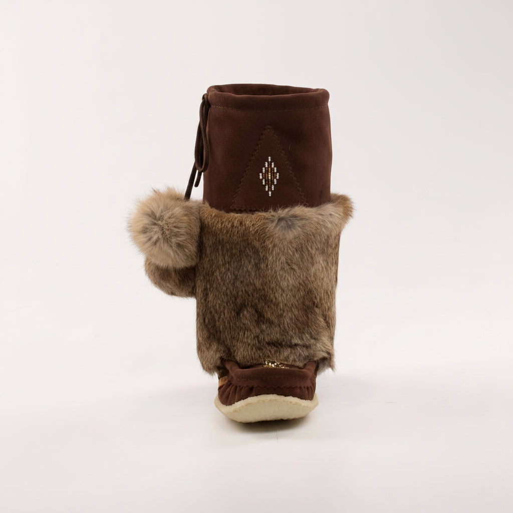 Brown mukluk boot with pom-pom on a white background