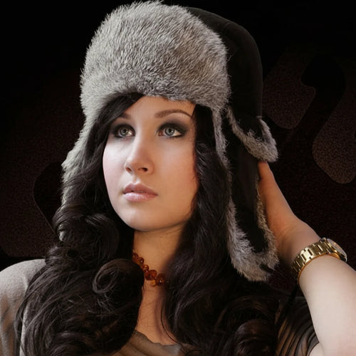 Woman wearing a fur hat against a dark background