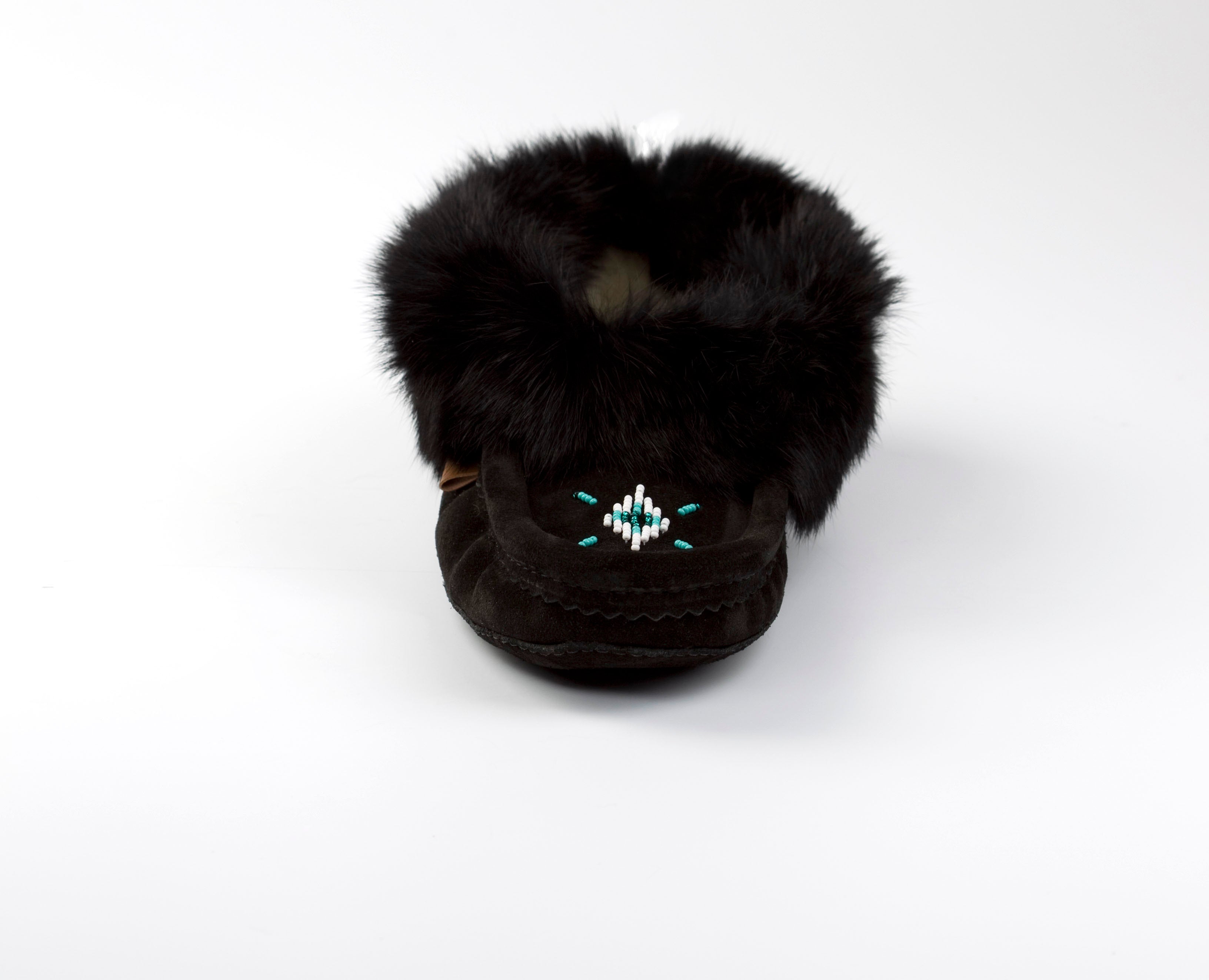 Black slippers with fur trim on a white background