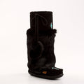 Black mukluk boot with fur trim on a white background