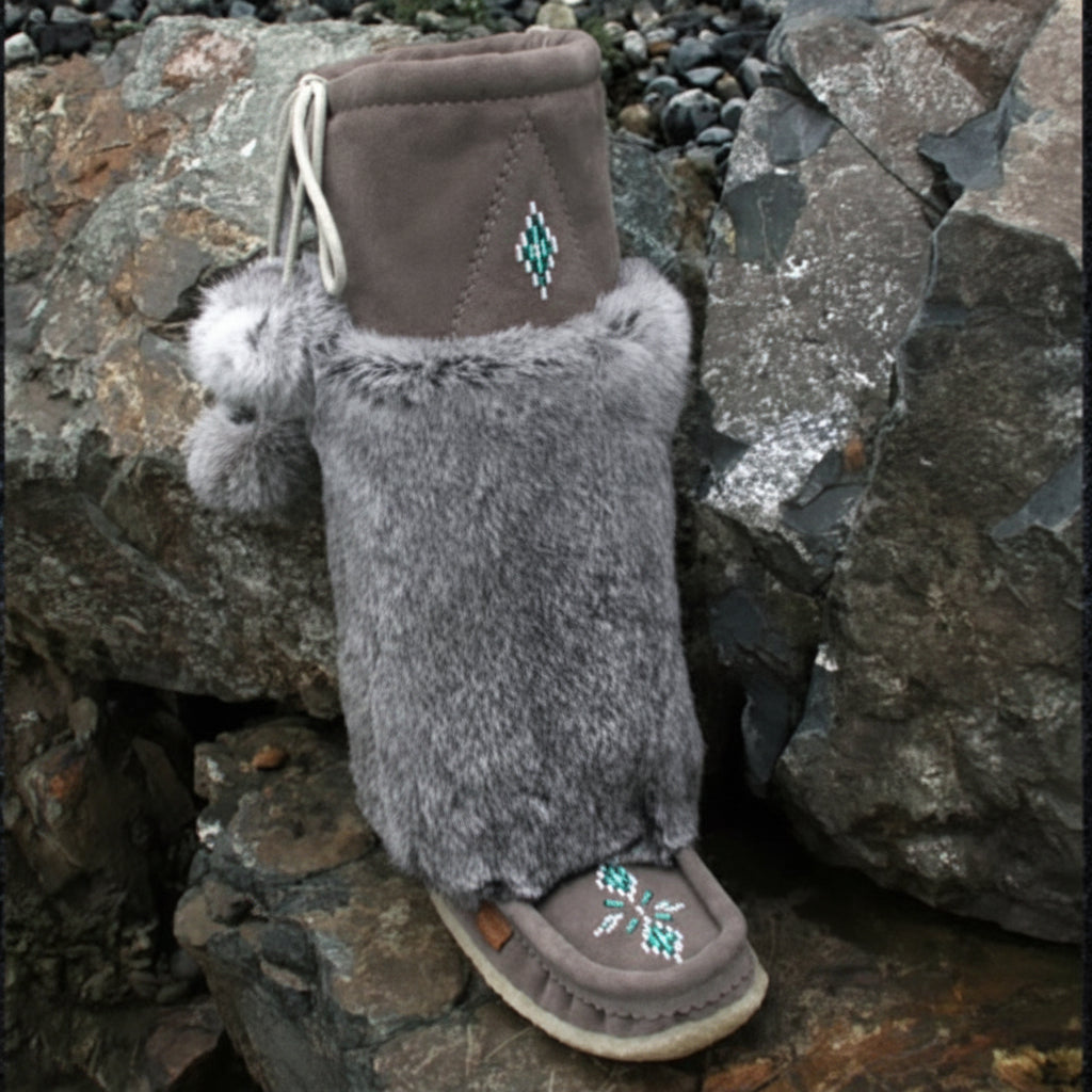 Tecumseh mukluks with fur on a stone background