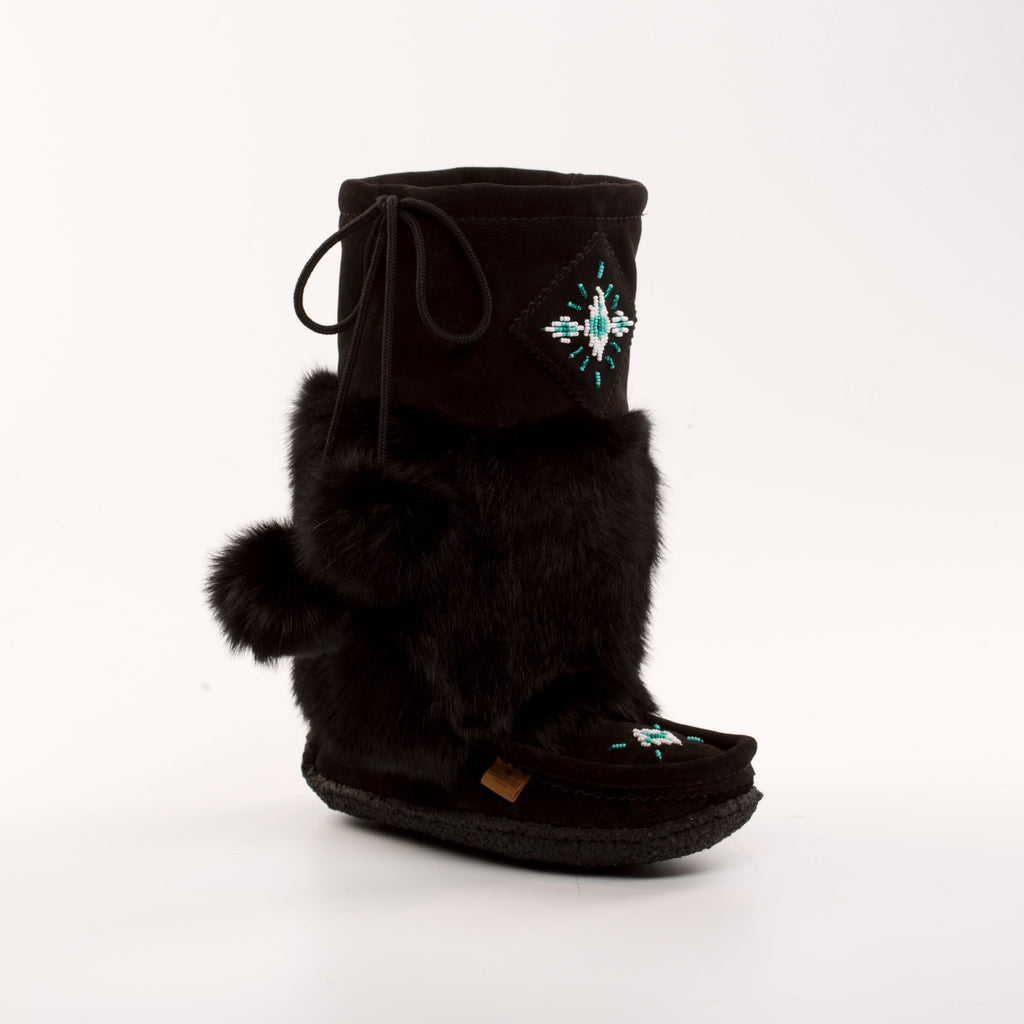 Black mukluk boot with fur trim and decorative element on a white background