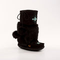 Black mukluk boot with fur trim and decorative element on a white background