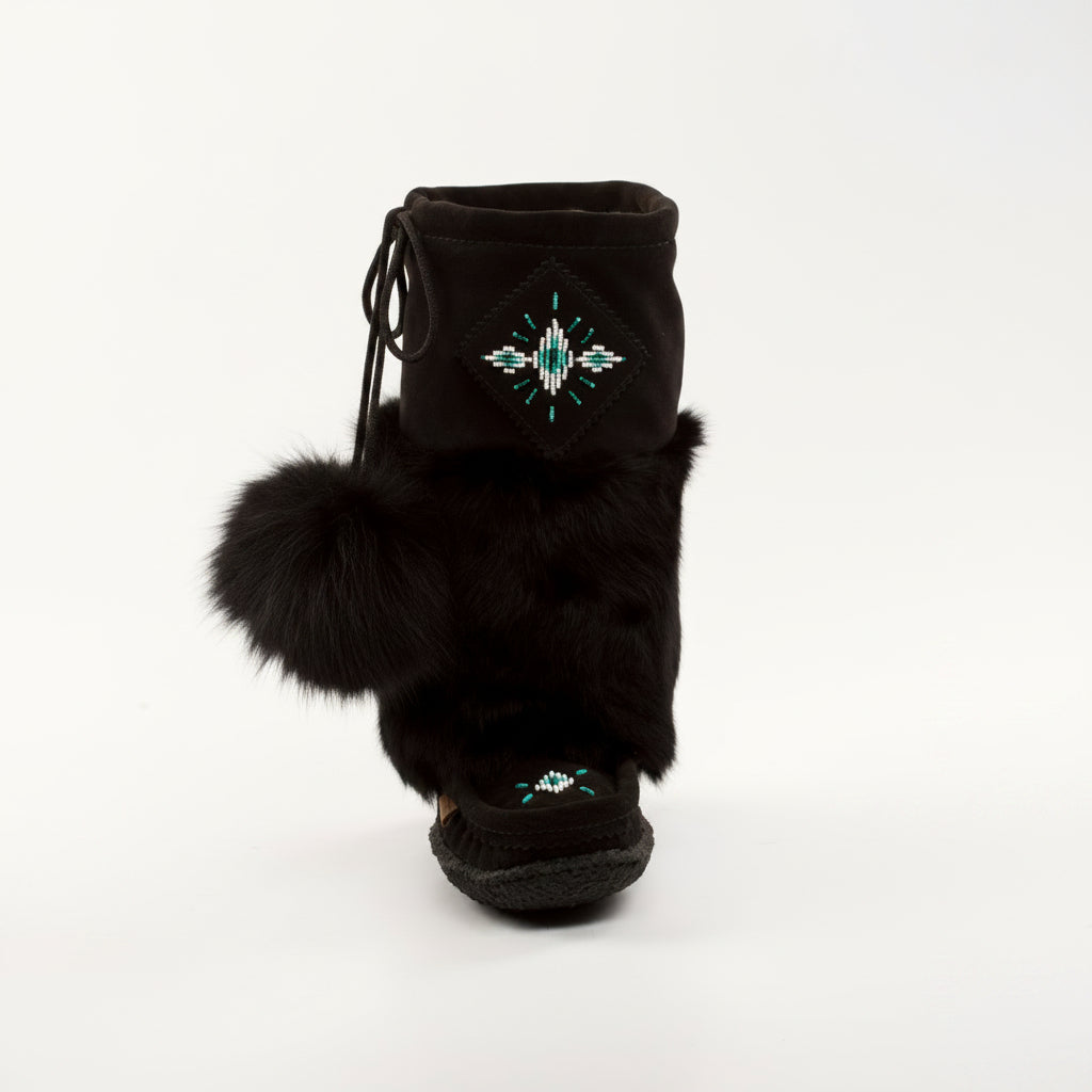 Black furry boot with decorative design on a white background