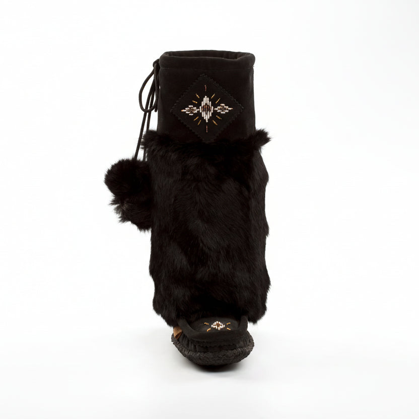 Black fur mukluk boots on white background
