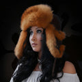 Woman wearing a fur hat against a dark background