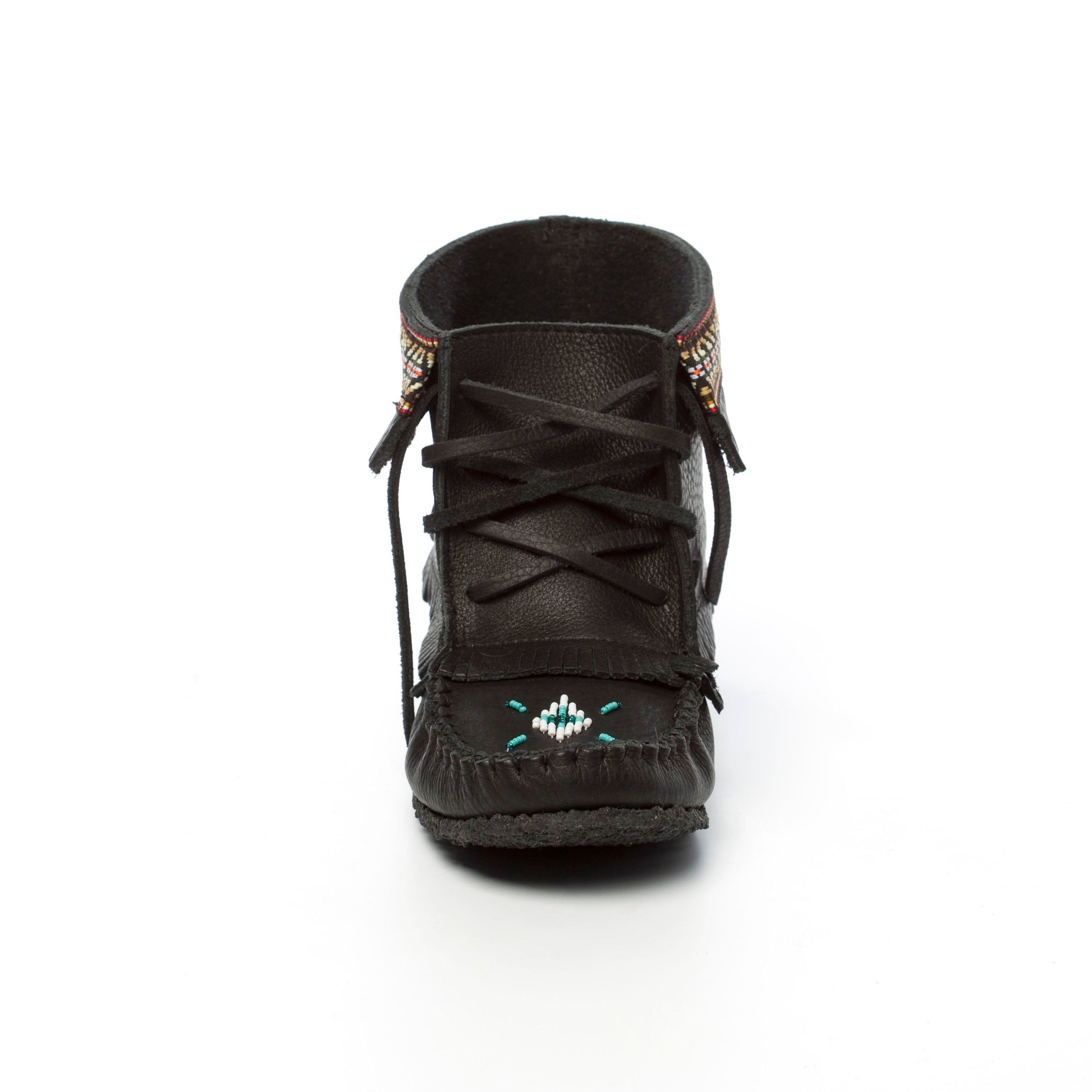 Black moccasin shoe with decorative elements on a white background