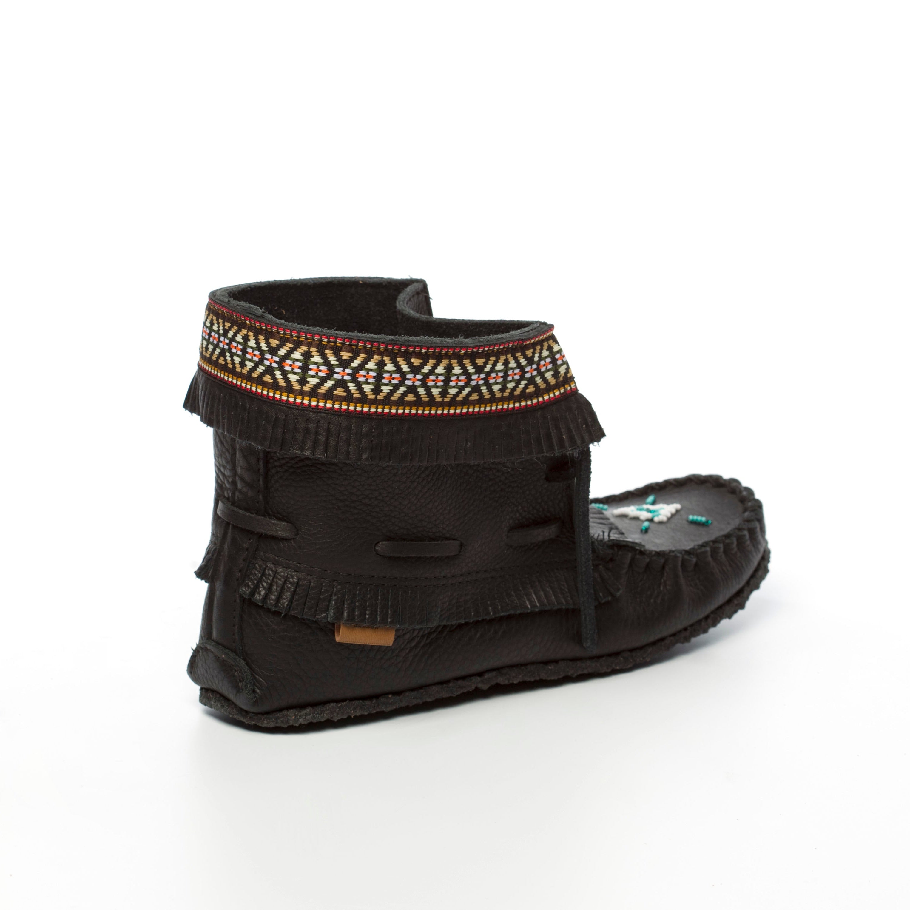 Black moccasin-style shoe with patterned band on a white background