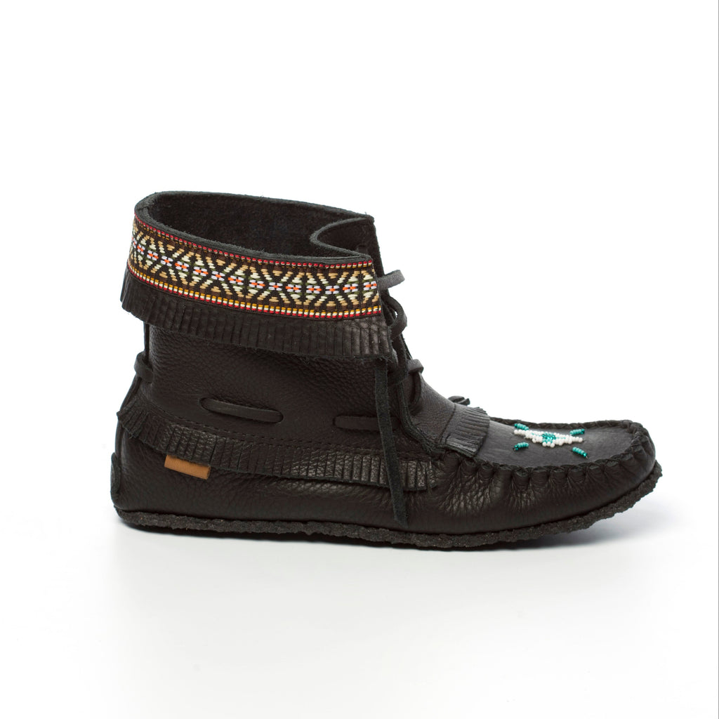 Black moccasin-style shoe with decorative band on a white background