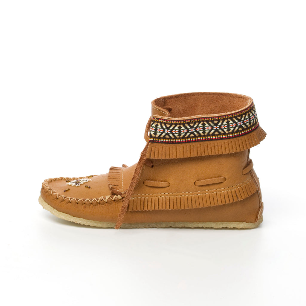 Brown moccasin shoe with decorative band on a white background