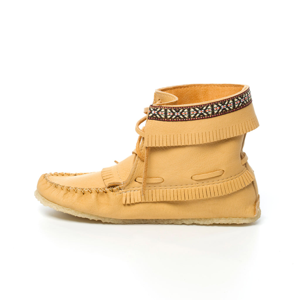 Beige moccasin-style shoe with decorative band on a white background