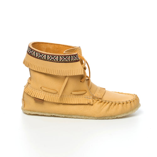Tan moccasin-style shoe with fringes and a patterned band on a white background