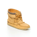 Tan moccasin boot with fringes on a white background