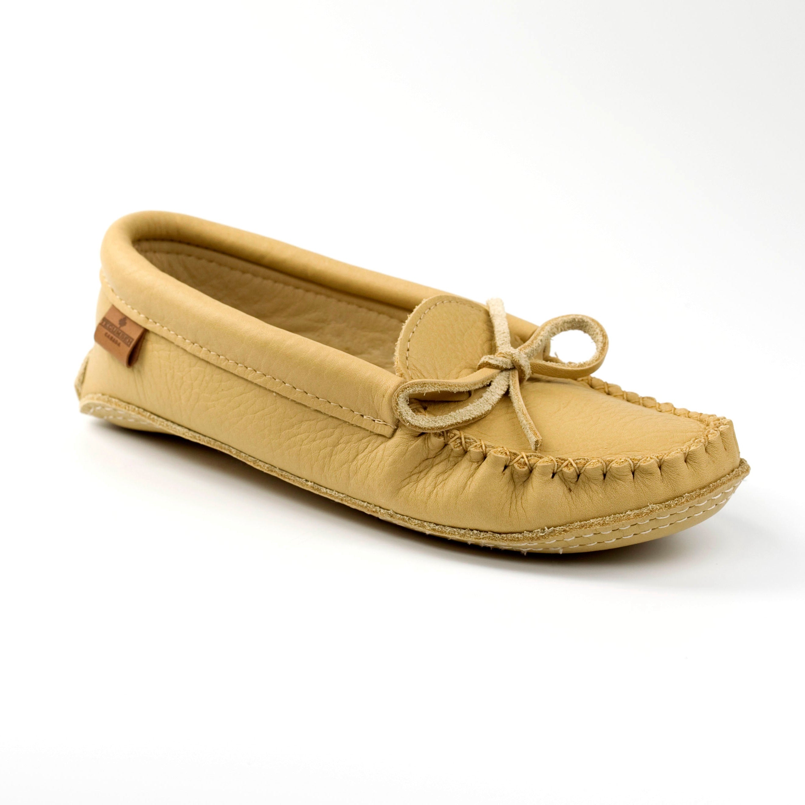 Tan moccasin shoe on a white background