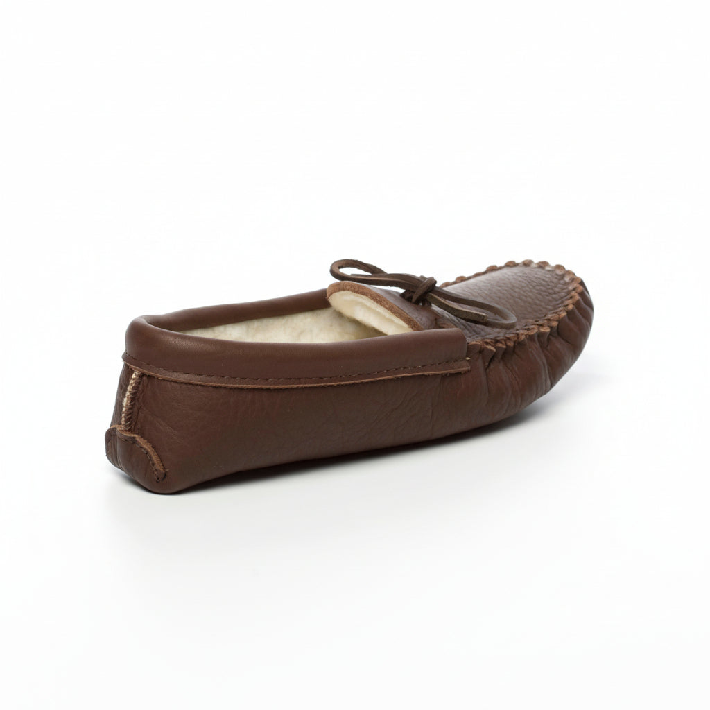 Brown moccasin slipper with fur lining on a white background