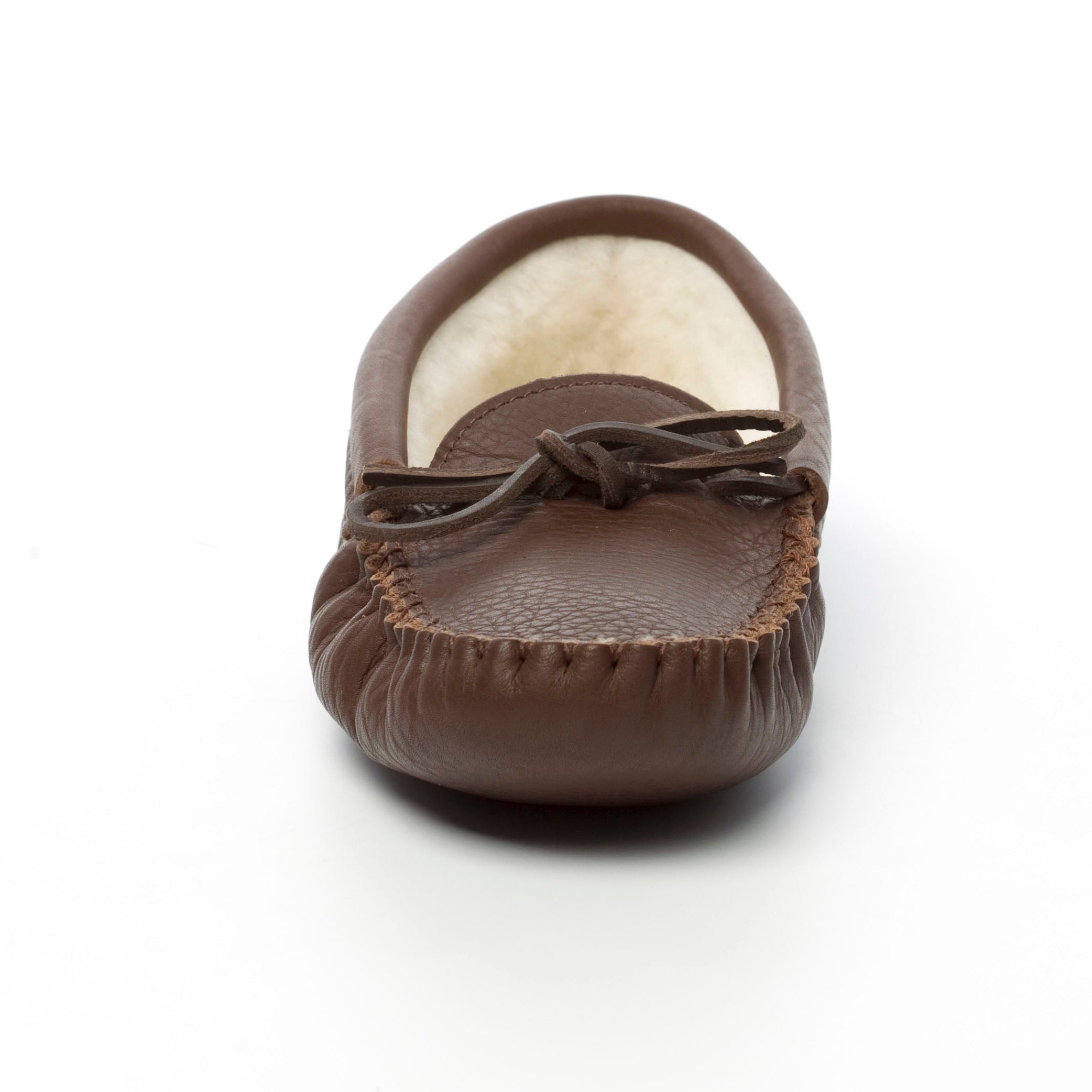 Brown moccasin shoe with white fur lining on a white background