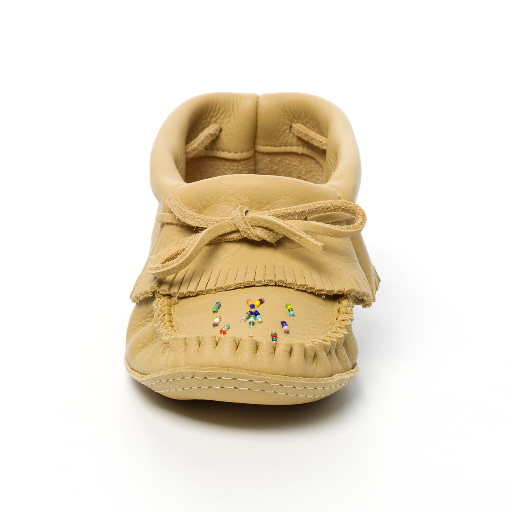 Beige moccasin shoe with colorful beads on a white background