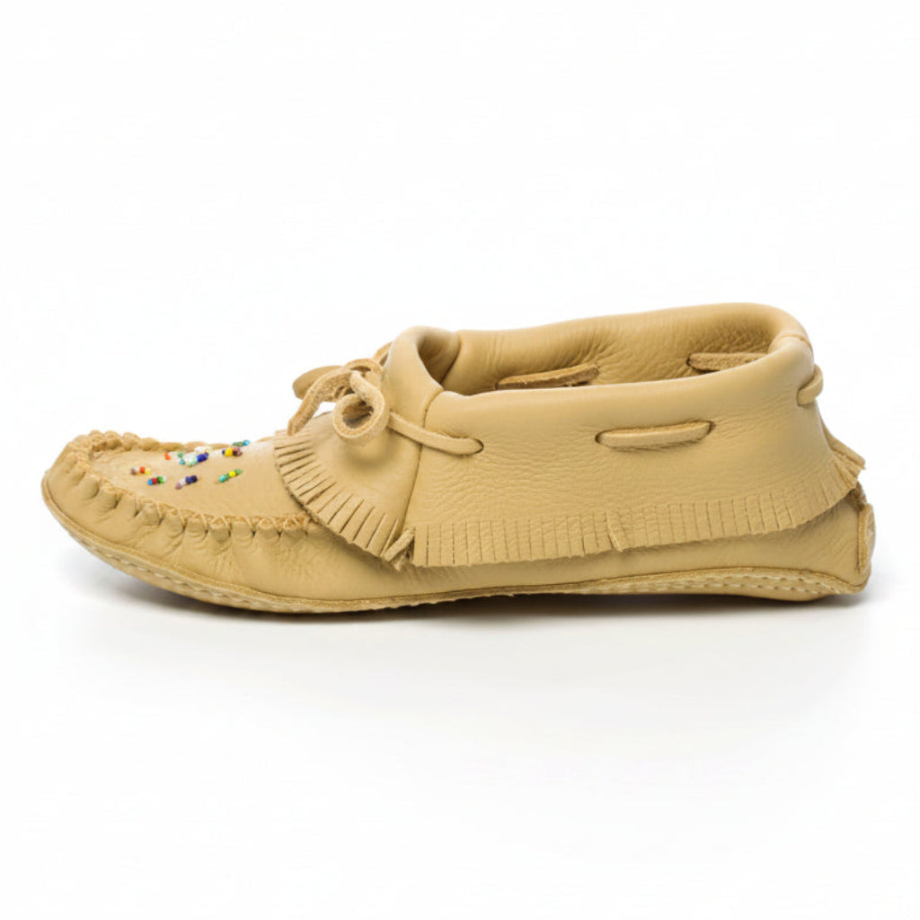 Beige moccasin shoe on a white background