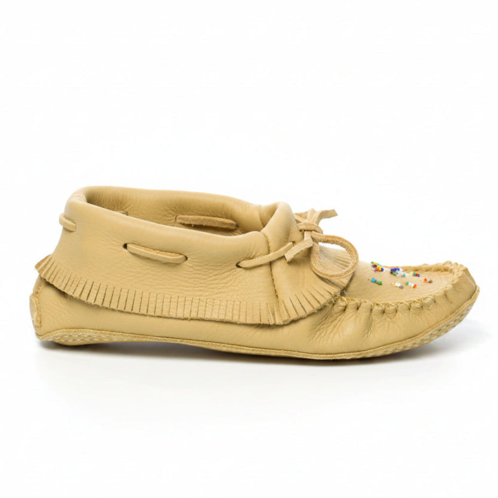 Beige moccasin shoe on a white background