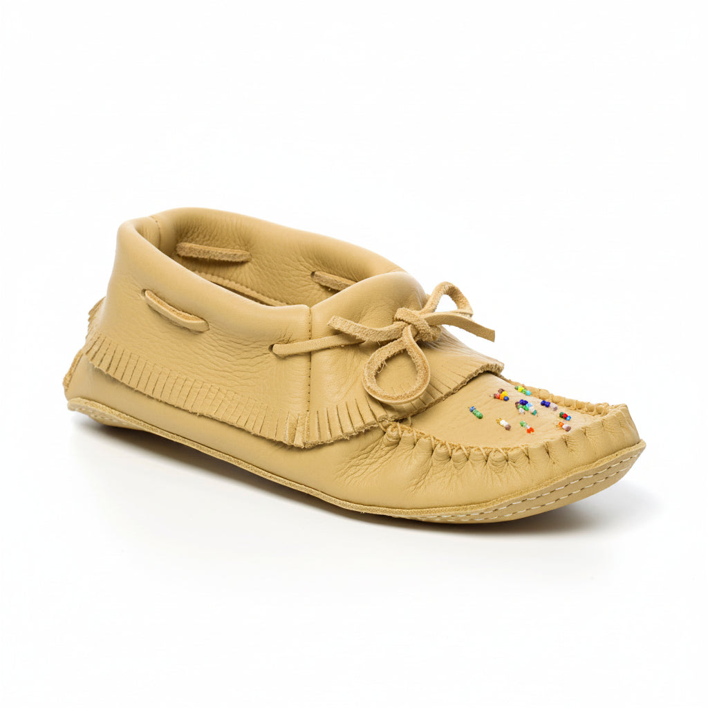 Beige moccasin shoe with fringes on a white background