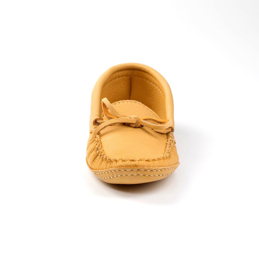 Yellow baby shoe with a bow on a white background