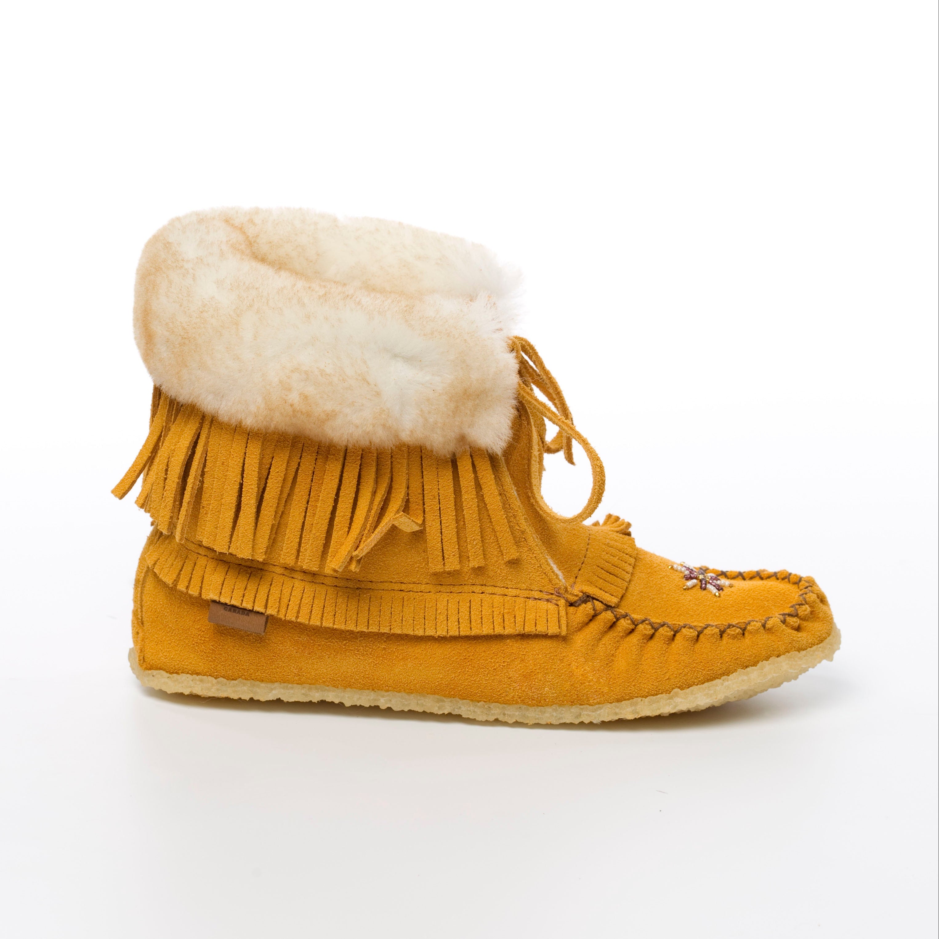 Mustard yellow moccasin boot with white fur lining on a white background