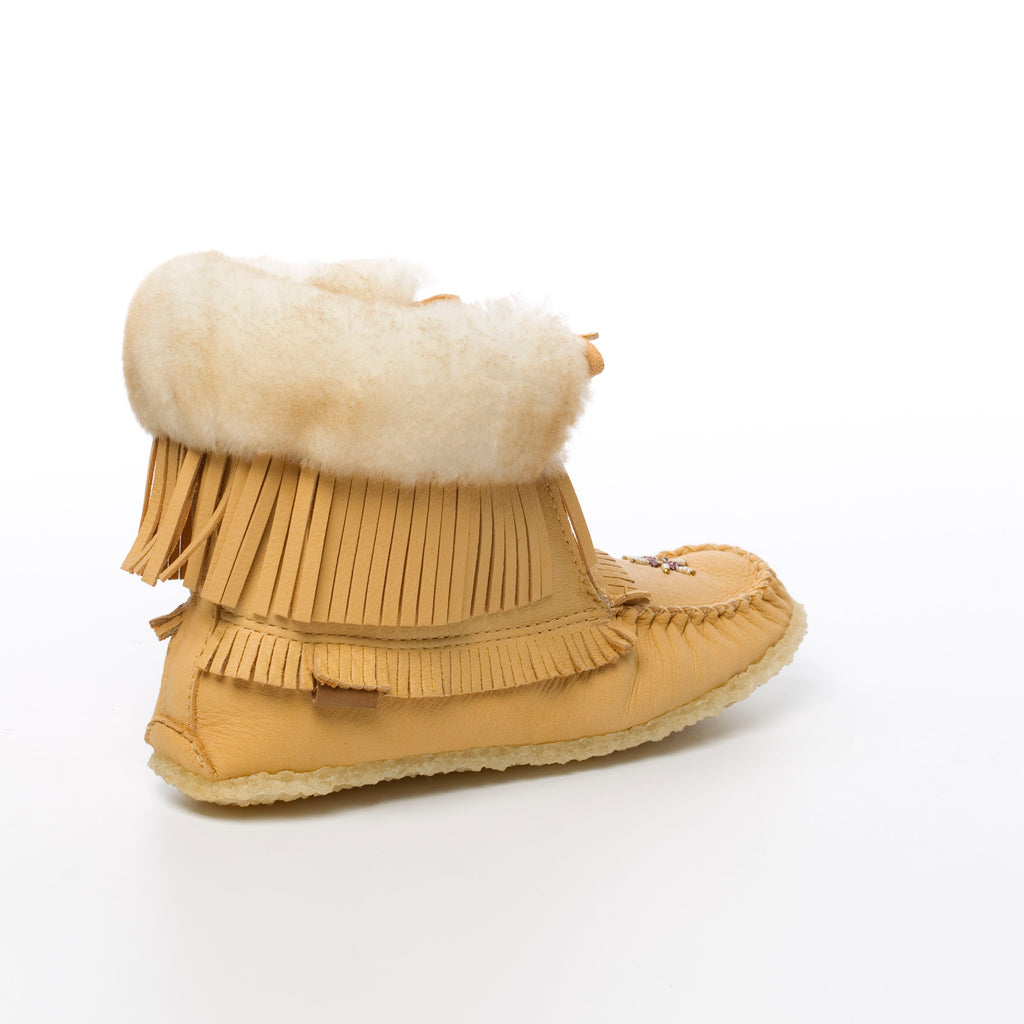 Moosehide moccasin ankle boots with fringes and sheepskin fur lining on a white background